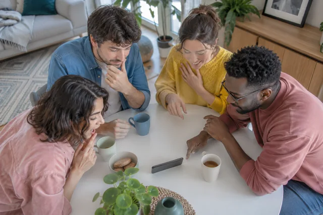 A small group works out an answer around a shared phone.
